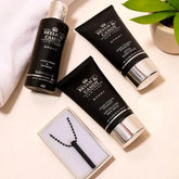 Infusion Men's Pamper Combo gift set with face wash, shower gel, aftershave balm, and black pendant on a cream background. Ideal for gifting men.